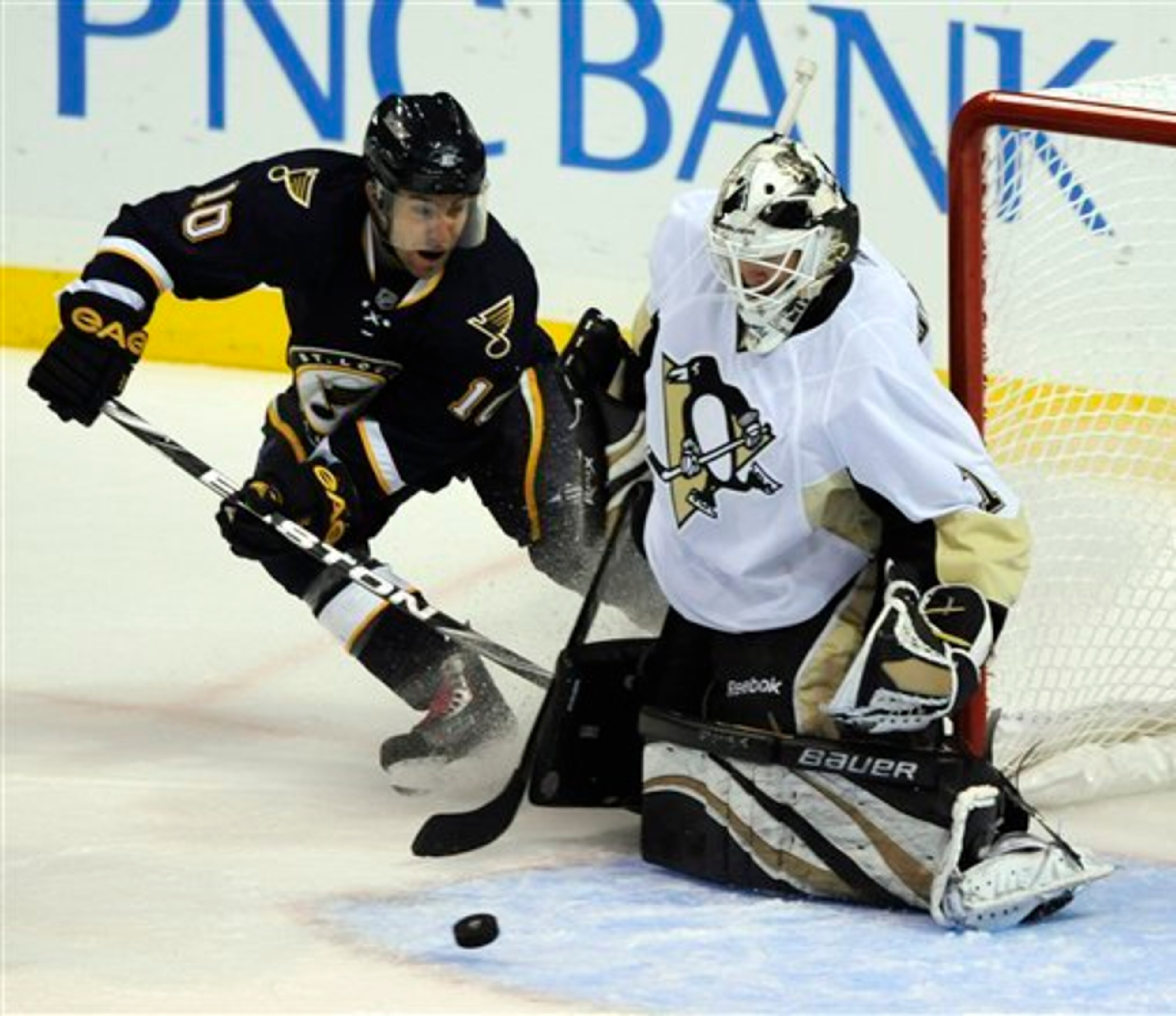 Pittsburgh Penguins' goalie Brent Johnson, right, blocks a shot by St. Louis Blues' Andy McDonald (10) in the second period of an NHL hockey game Saturday, Oct. 23, 2010, in St. Louis.(AP Photo/Bill Boyce)