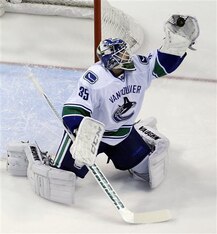 Vancouver Canucks goalie Cory Schneider makes a glove save during the first period of an NHL hockey game against the St. Louis Blues Tuesday, April 16, 2013, in St. Louis. (AP Photo/Jeff Roberson)