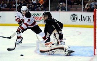 New Jersey Devils left wing Zach Parise, left, tires to get a shot in on Anaheim Ducks goalie Jonas Hiller of Switzerland during the first period of their NHL hockey game, Friday, Oct. 29, 2010, in Anaheim, Calif.  (AP Photo/Mark J. Terrill)