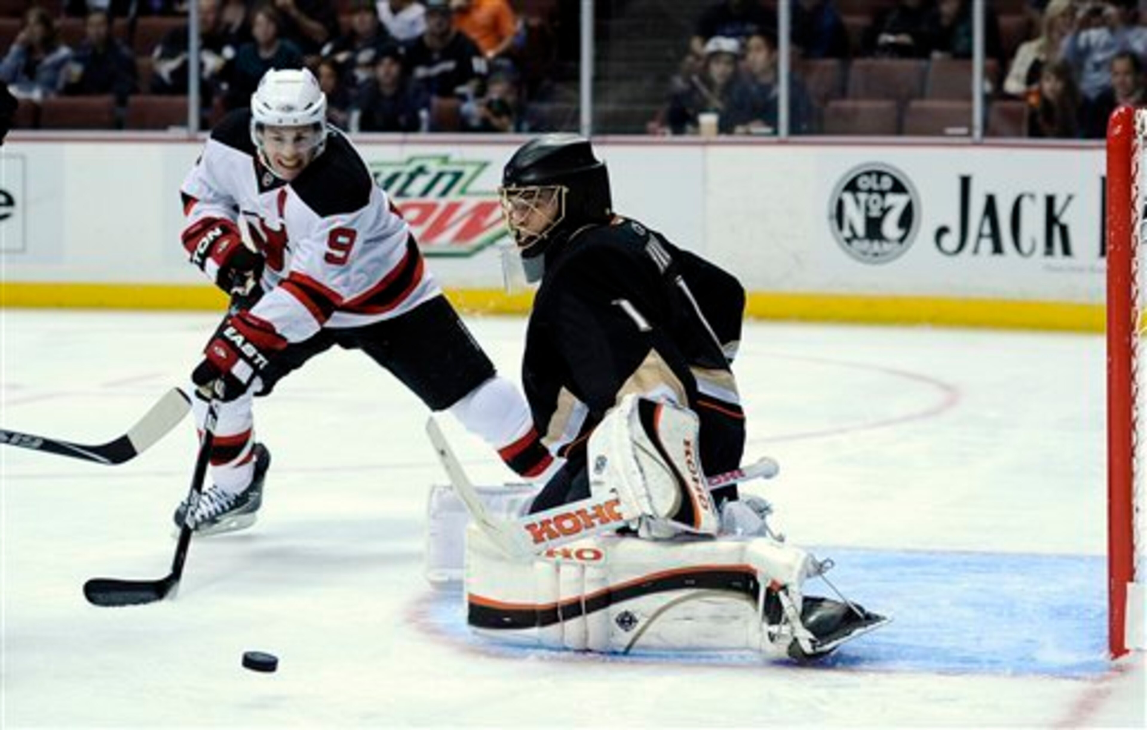 New Jersey Devils left wing Zach Parise, left, tires to get a shot in on Anaheim Ducks goalie Jonas Hiller of Switzerland during the first period of their NHL hockey game, Friday, Oct. 29, 2010, in Anaheim, Calif.  (AP Photo/Mark J. Terrill)