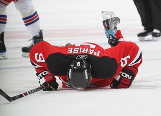 NEWARK, NJ - NOVEMBER 12:  Zach Parise #9 of the New Jersey Devils lays injured on the ice against the New York Rangers during the NHL game on November 12, 2008 at the Prudential Center in Newark, New Jersey.  The Rangers defeated the Devils 5-2. (Photo b