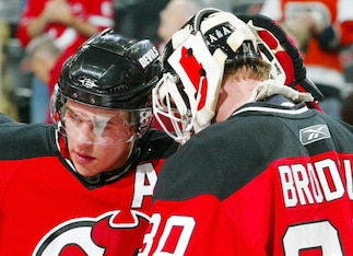 NEWARK, NJ - DECEMBER 12: Martin Brodeur #30 of the New Jersey Devils is congratulated by Zach Parise #9 after defeating the Philadelphia Flyers at the Prudential Center on December 12, 2009 in Newark, New Jersey.  (Photo by Andy Marlin/NHLI via Getty Ima