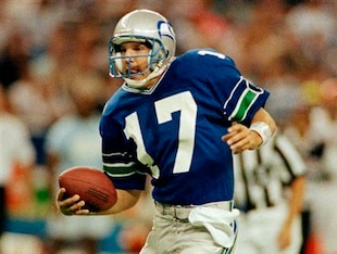Seattle's quarterback Dave Krieg steps away from a Cincinnati defender in the second half of NFL game in Seattle, Oct. 1, 1990. (AP Photo/Bill Chan)