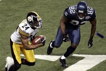 Pittsburgh Steelers cornerback Ike Taylor heads downfield after pulling in an interception thrown by Seattle Seahawks quarterback Matt Hasselbeck during the fourth quarter of the Super Bowl XL football game, Sunday, Feb. 5, 2006, in Detroit. At right is S