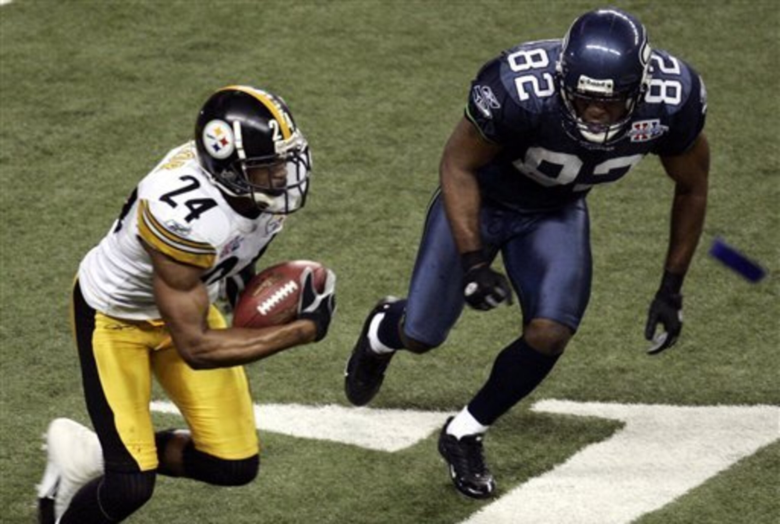 Pittsburgh Steelers cornerback Ike Taylor heads downfield after pulling in an interception thrown by Seattle Seahawks quarterback Matt Hasselbeck during the fourth quarter of the Super Bowl XL football game, Sunday, Feb. 5, 2006, in Detroit. At right is S