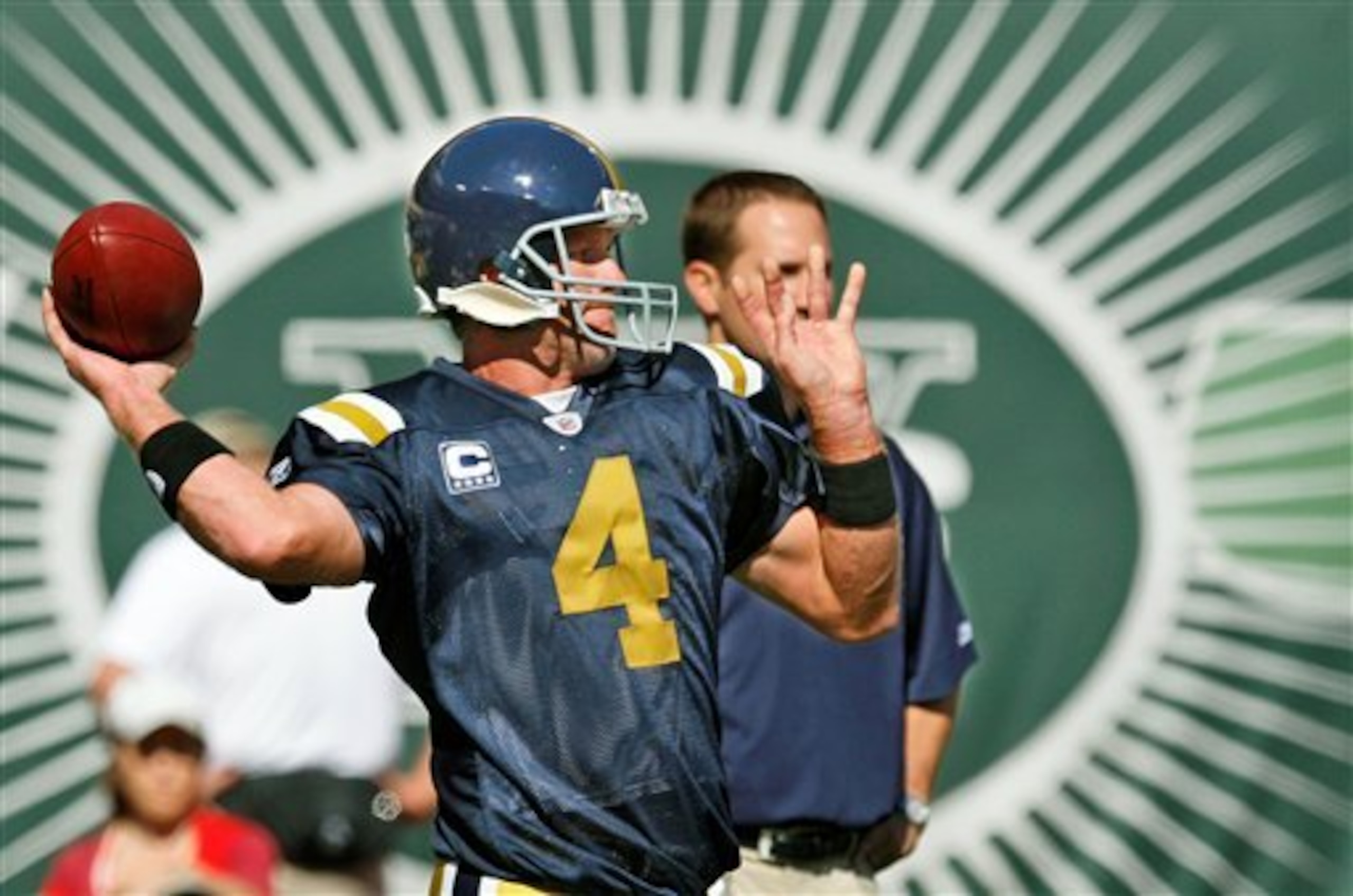 Wearing a throwback New York Titans uniform, New York Jets quarterback Brett Favre drops back for a pass during pregame warmups before the Jets faced the Cincinnati Bengals in their NFL football game at Giants Stadium in East Rutherford, N.J., Sunday, Oct