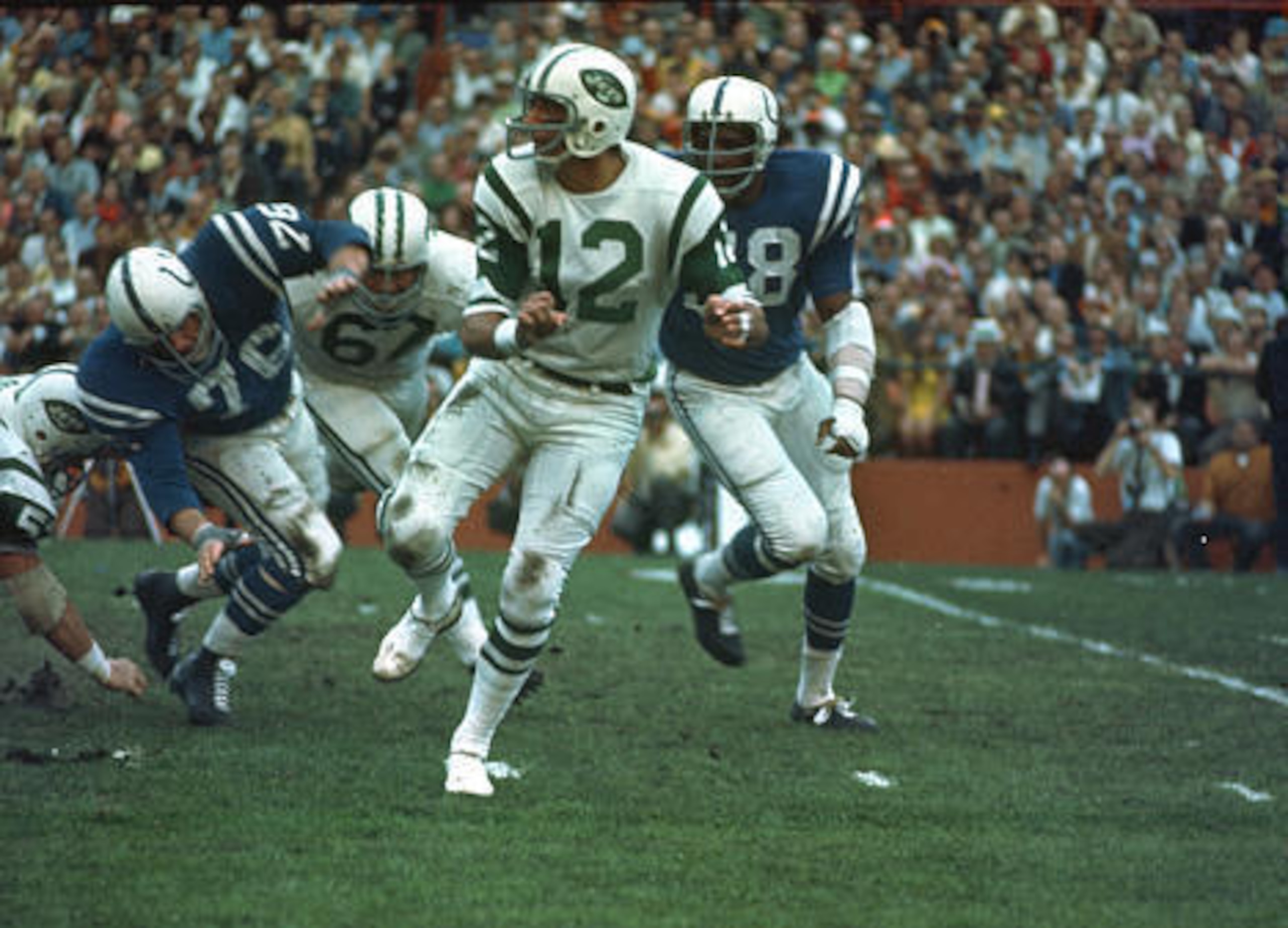 New York Jets quarterback (12) Joe Namath gets off a pass under pressure from the Baltimore Colts defenders during Super Bowl III in Miami, Fla., on Sunday, Jan. 12, 1969.  (AP Photo)
