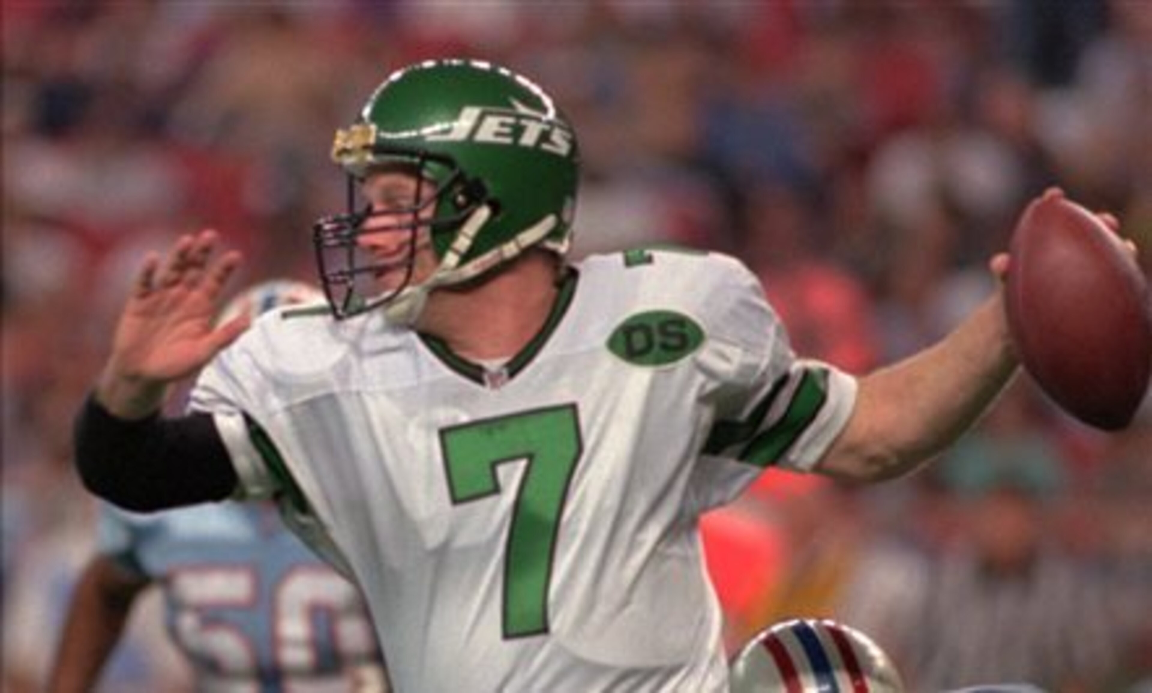 FILE- In this Dec. 17, 1995 file photo, New York Jets quarterback Boomer Esiason (7) is grabbed from behind by Houston Oilers defender Henry Ford (92) during an NFL football game in Houston. After an already terrific career in Cincinnati, which included l