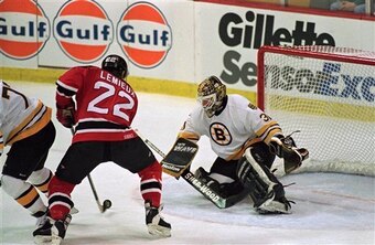 New Jersey Devils right wing Claude Lemieux (22) sets up one of his two goals in front of Boston Bruins goalie Blaine Lacher in the first period of their playoff series at the Boston Garden in Boston, Sunday, May 7, 1995. (AP Photo/Winslow Townson)