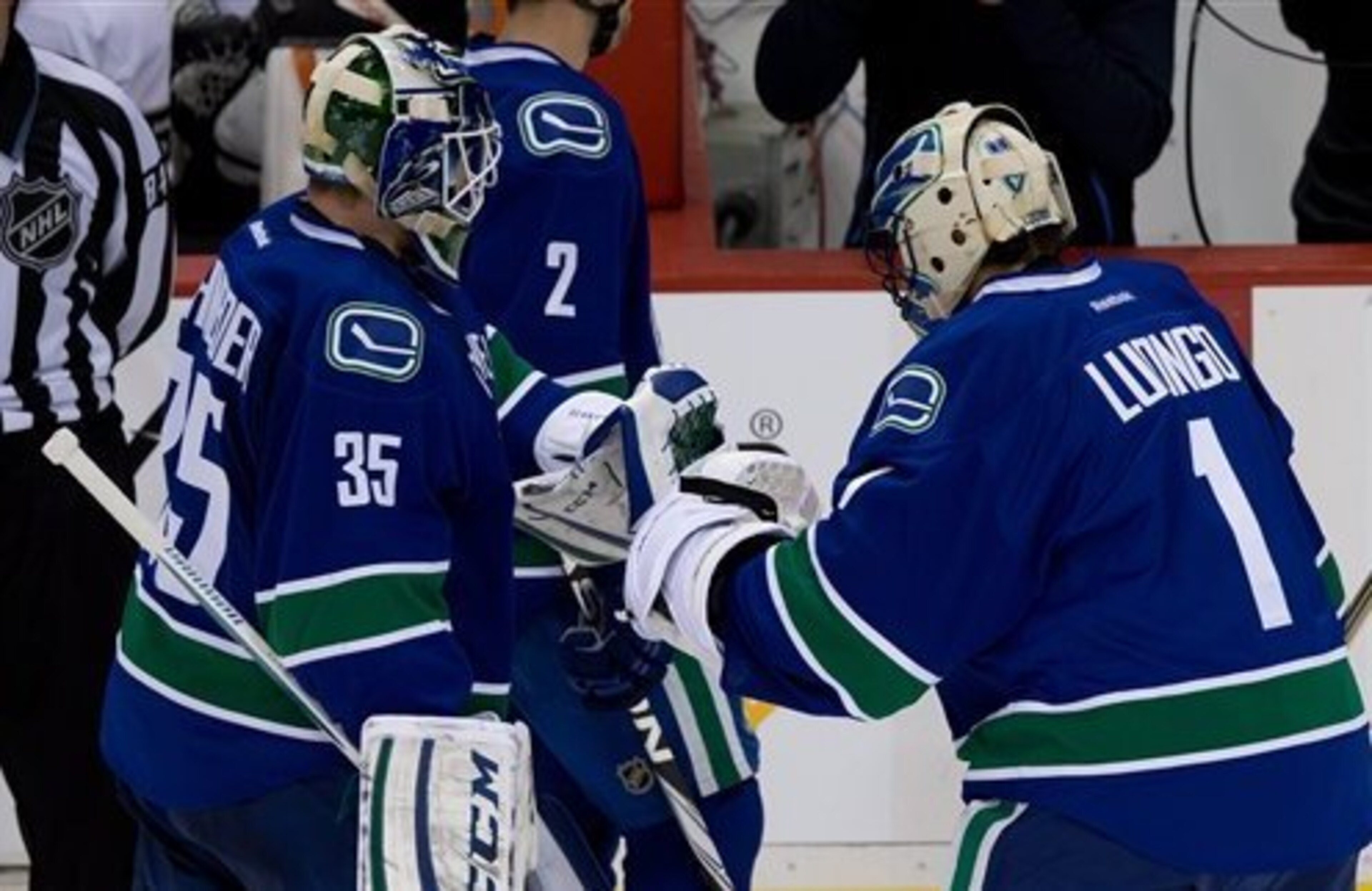 Vancouver Canucks' goalie Roberto Luongo, right, comes off the bench to replace goalie Cory Schneider after Schneider allowed a five goals to the Anaheim Ducks during second period NHL hockey action in Vancouver on Saturday, January 19, 2013. THE CANADIAN Vancouver Canucks' goalie Roberto Luongo, right, comes off the bench to replace goalie Cory Schneider after Schneider allowed a five goals to the Anaheim Ducks during second period NHL hockey action in Vancouver on Saturday, January 19, 2013. THE CANADIAN