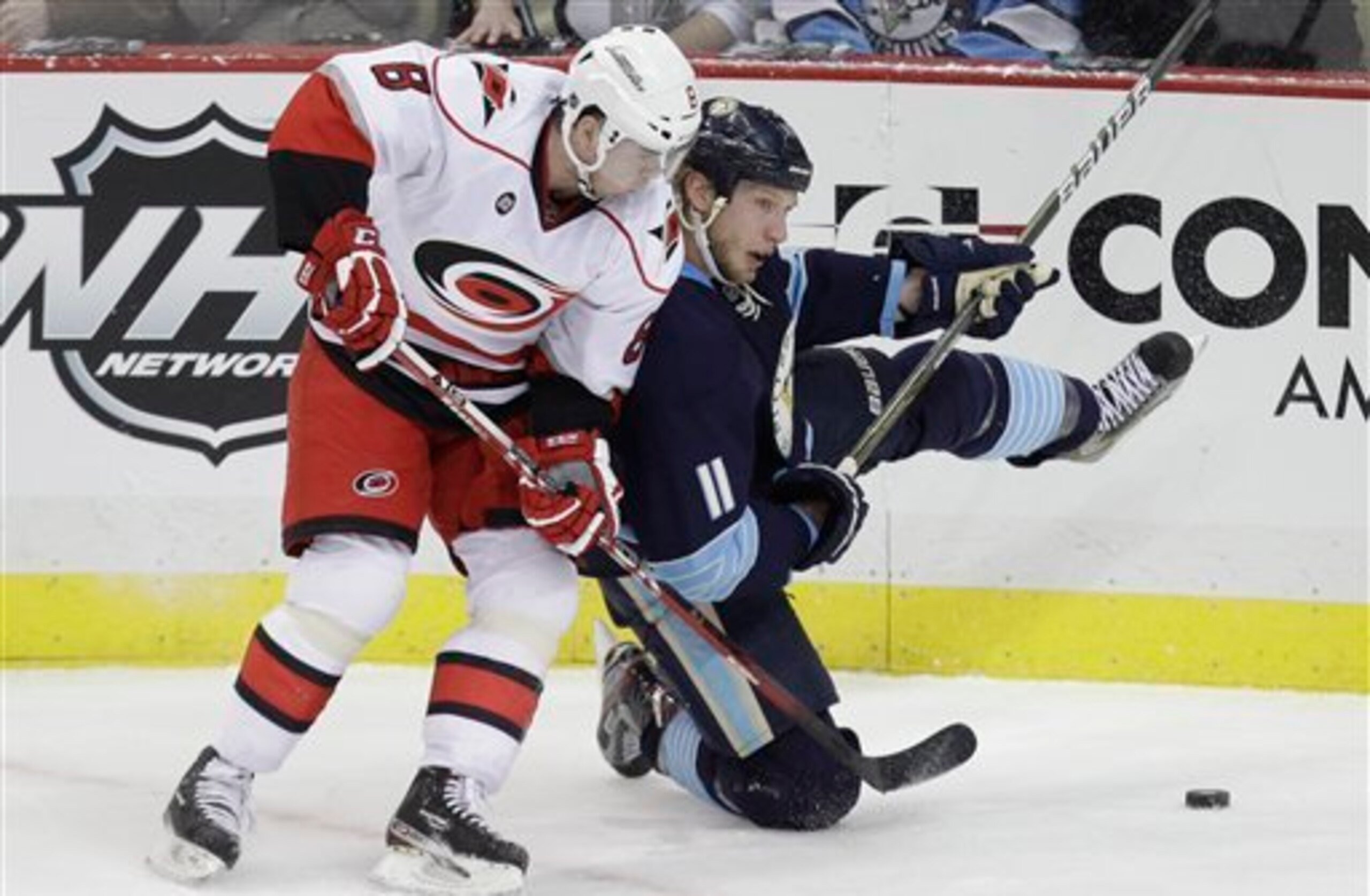 Pittsburgh Penguins' Jordan Staal (11) collides with Carolina Hurricanes' Jaroslav Spacek (8) in the first period of an NHL hockey game in Pittsburgh Tuesday, Dec. 27, 2011.  (AP Photo/Gene J. Puskar)