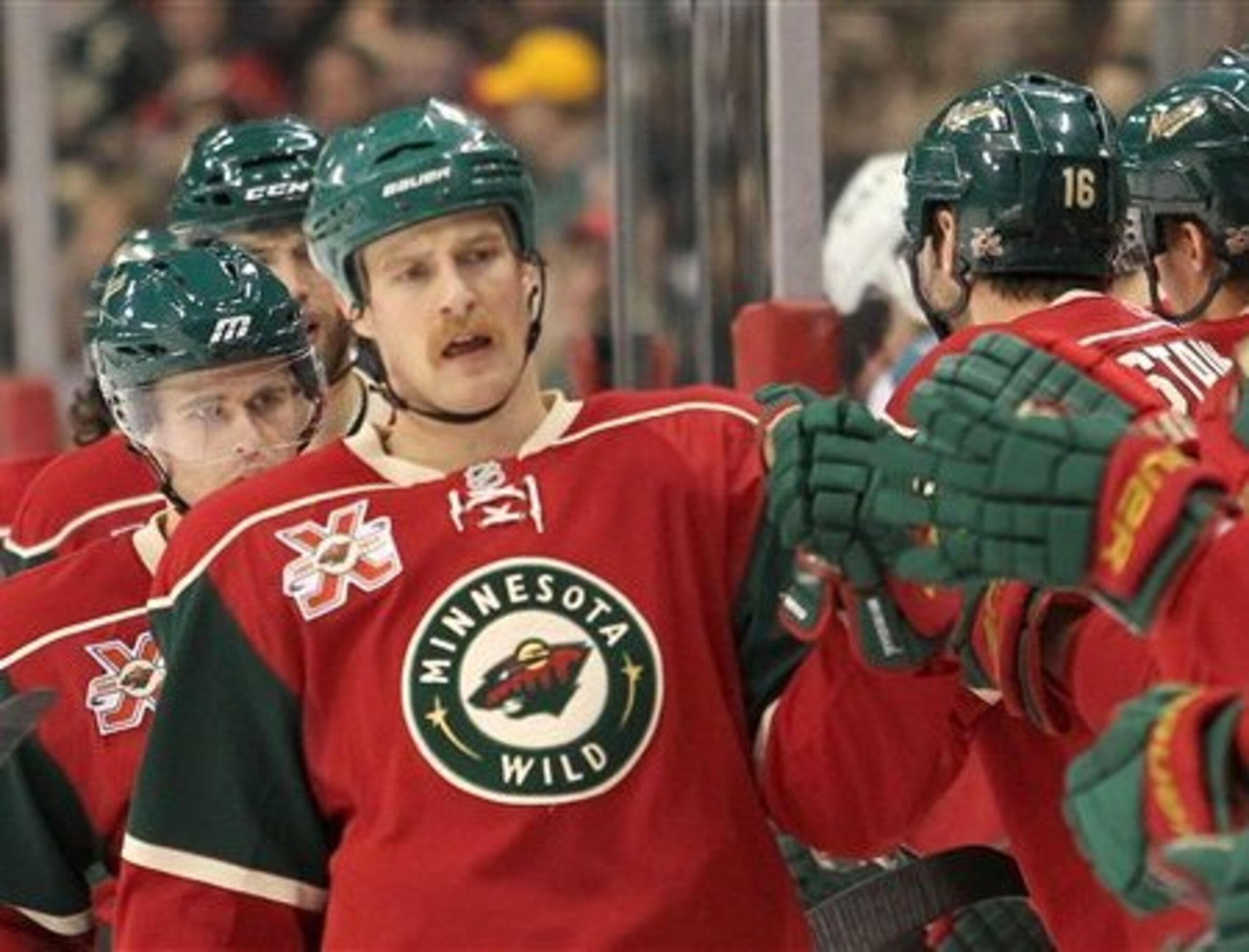Minnesota Wild's Kyle Brodziak is congratulated by teammates after he scored in the first period against the San Jose Sharks in an NHL hockey game in St. Paul, Minn., Wednesday, Dec. 29, 2010. (AP Photo/Andy King)