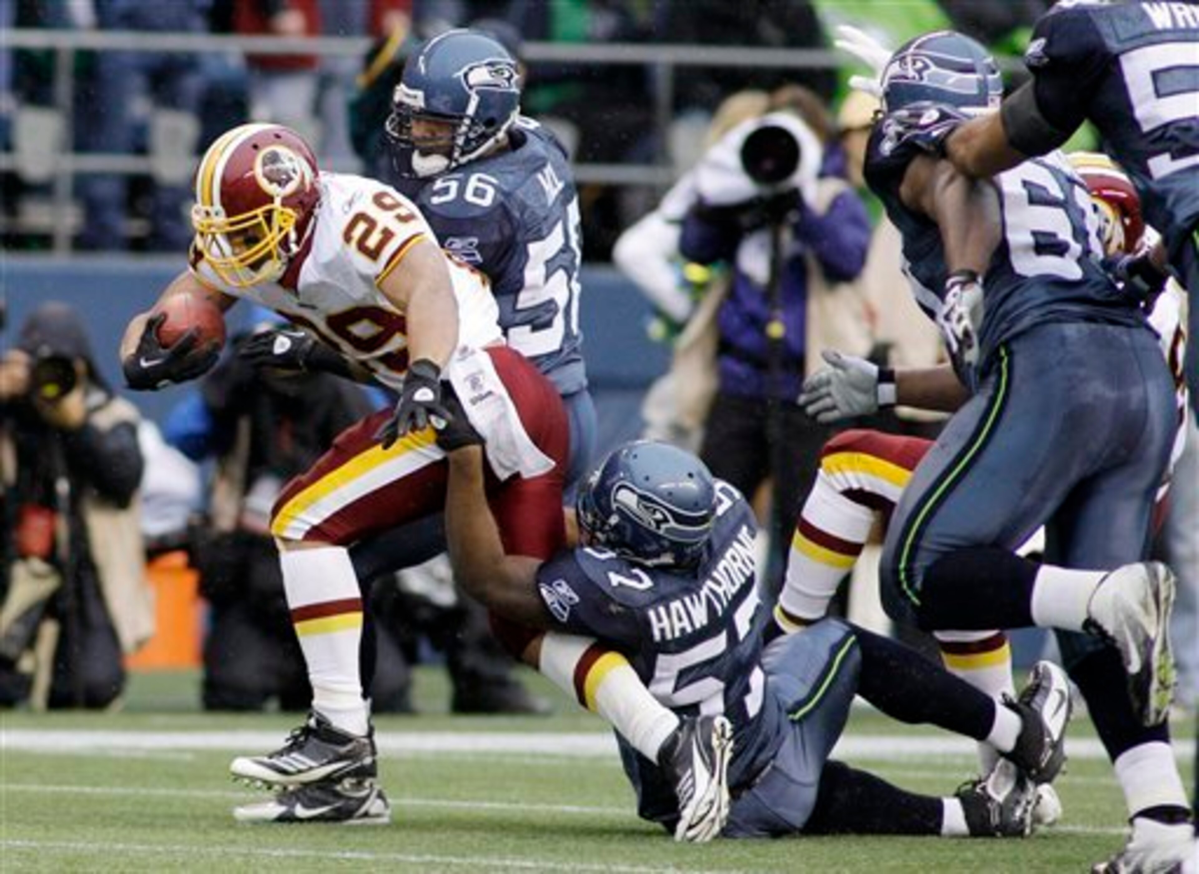 Washington Redskins Roy Helu breaks a tackle from Seattle Seahawks David Hawthorne (57) in the first half of an NFL football game, Sunday, Nov. 27, 2011, in Seattle. (AP Photo/Ted S. Warren)