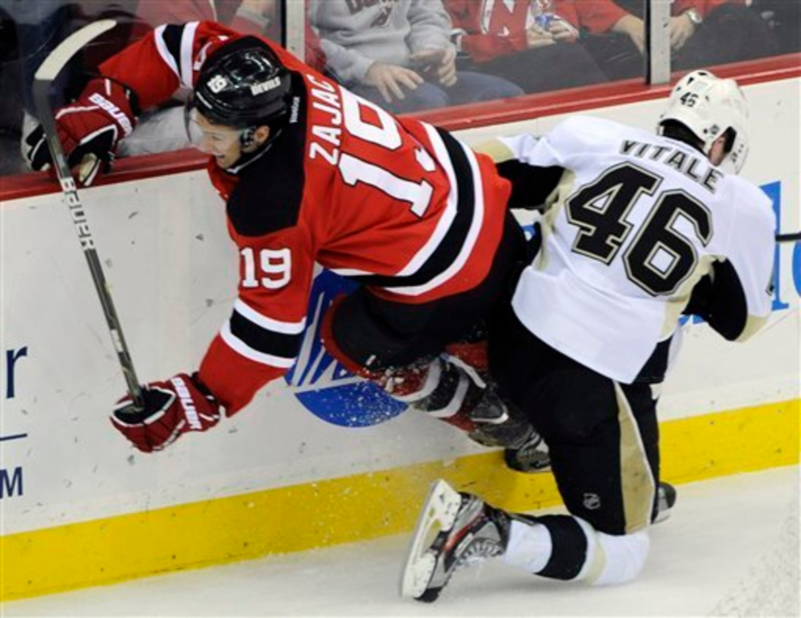 New Jersey Devils' Travis Zajac attempts to squeeze through as he is checked by Pittsburgh Penguins' Joe Vitale, right, during the third period of an NHL hockey game Saturday, Dec. 31, 2011, in Newark, N.J. The Devils won 3-1. (AP Photo/Bill Kostroun) New Jersey Devils' Travis Zajac attempts to squeeze through as he is checked by Pittsburgh Penguins' Joe Vitale, right, during the third period of an NHL hockey game Saturday, Dec. 31, 2011, in Newark, N.J. The Devils won 3-1. (AP Photo/Bill Kostroun)
