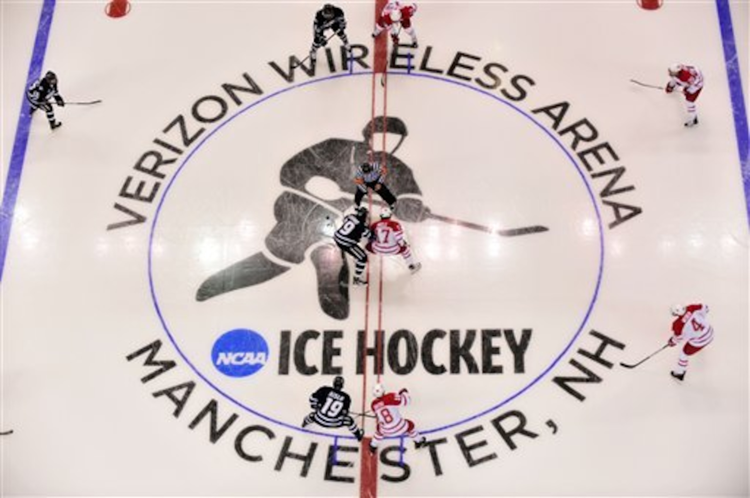 The puck drops at center ice kicking off a Northeast regional semifinal game in the NCAA college hockey tournament in Manchester, N.H., Saturday, March 26, 2011.  (AP Photo/Josh Gibney)