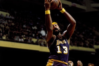 BOSTON - 1972:  Wilt Chamberlain #13 of the Los Angeles Lakers rebounds against the Boston Celtics during a game played circa 1972 at the Boston Garden in Boston, Massachusetts. NOTE TO USER: User expressly acknowledges that, by downloading and or using t