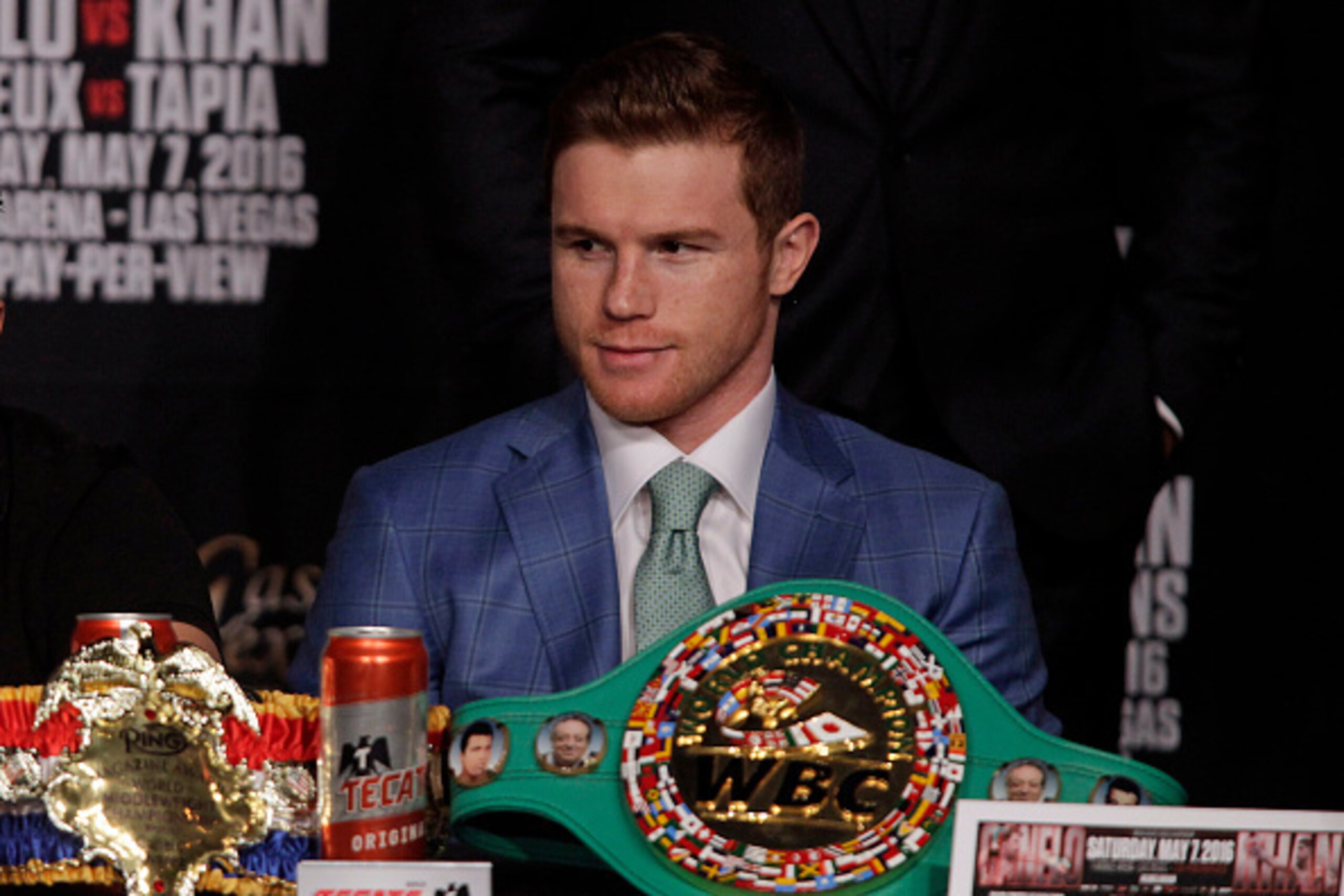 Boxer Saul 'Canelo' Alvarez from Mexico looks on as England's Amir Khan speaks during their final press conference at the MGM Grand in Las Vegas, Nevada on May 4, 2016 . 
The boxers will fight for the WBC Middleweight title on May 7, 2016 at the T-Mobile 