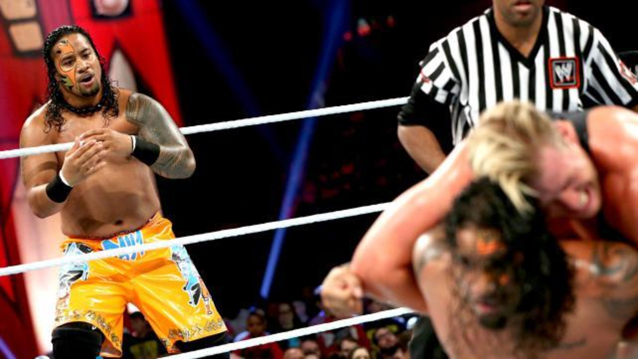 One of the Uso brothers looks on as the other is pummeled by Jack Swagger. (Courtesy of WWE.com)
