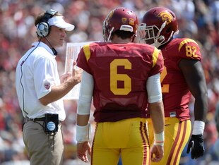 Kiffin talking to his quarterback and tight end.