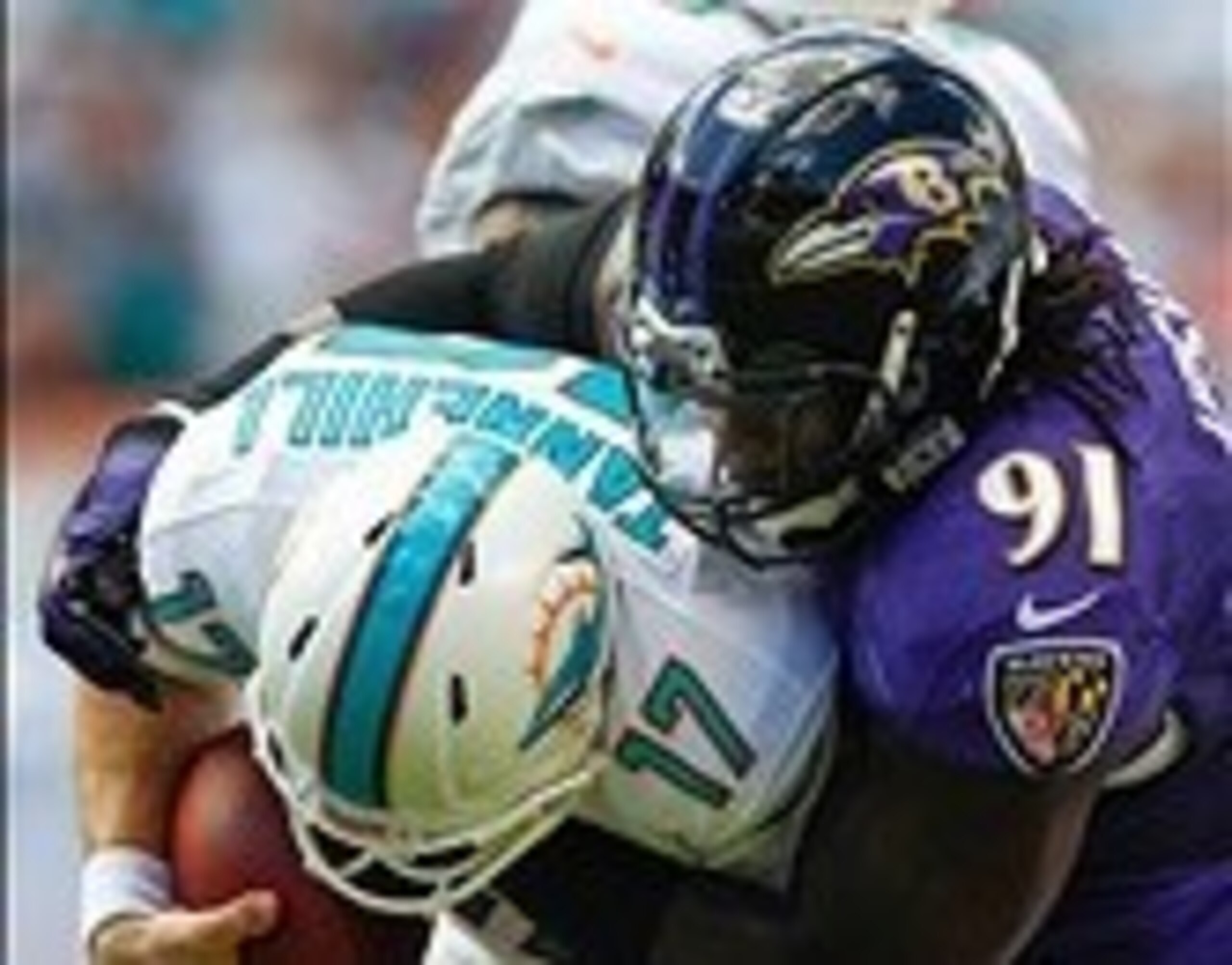 Oct 6, 2013; Miami Gardens, FL, USA; Baltimore Ravens outside linebacker Courtney Upshaw (91) sacks Miami Dolphins quarterback Ryan Tannehill (17) in the first quarter at Sun Life Stadium. Mandatory Credit: Robert Mayer-USA TODAY Sports