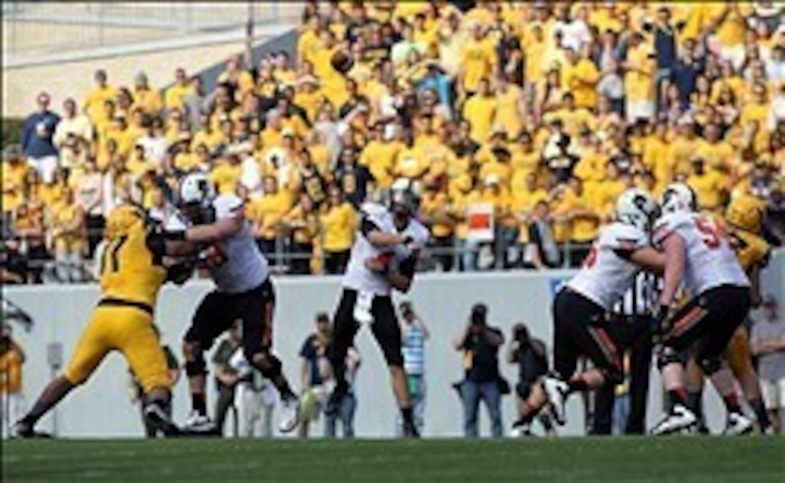 Sep 28, 2013; Morgantown, WV, USA; Oklahoma State Cowboys quarterback J.W. Walsh (4) passes the ball against the West Virginia Mountaineers at Milan Puskar Stadium. Mandatory Credit: Peter Casey-USA TODAY Sports