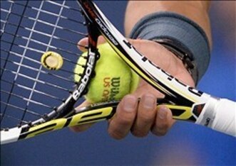 Rafael Nadal gently cradles his Babolat Aero Pro Drive before he pounds a ball with it at the 2013 U.S. Open.