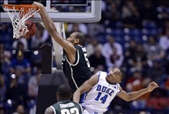 Michigan State's Adreian Payne dunks over Duke's Rasheed Sulaimon in a Sweet 16 loss.