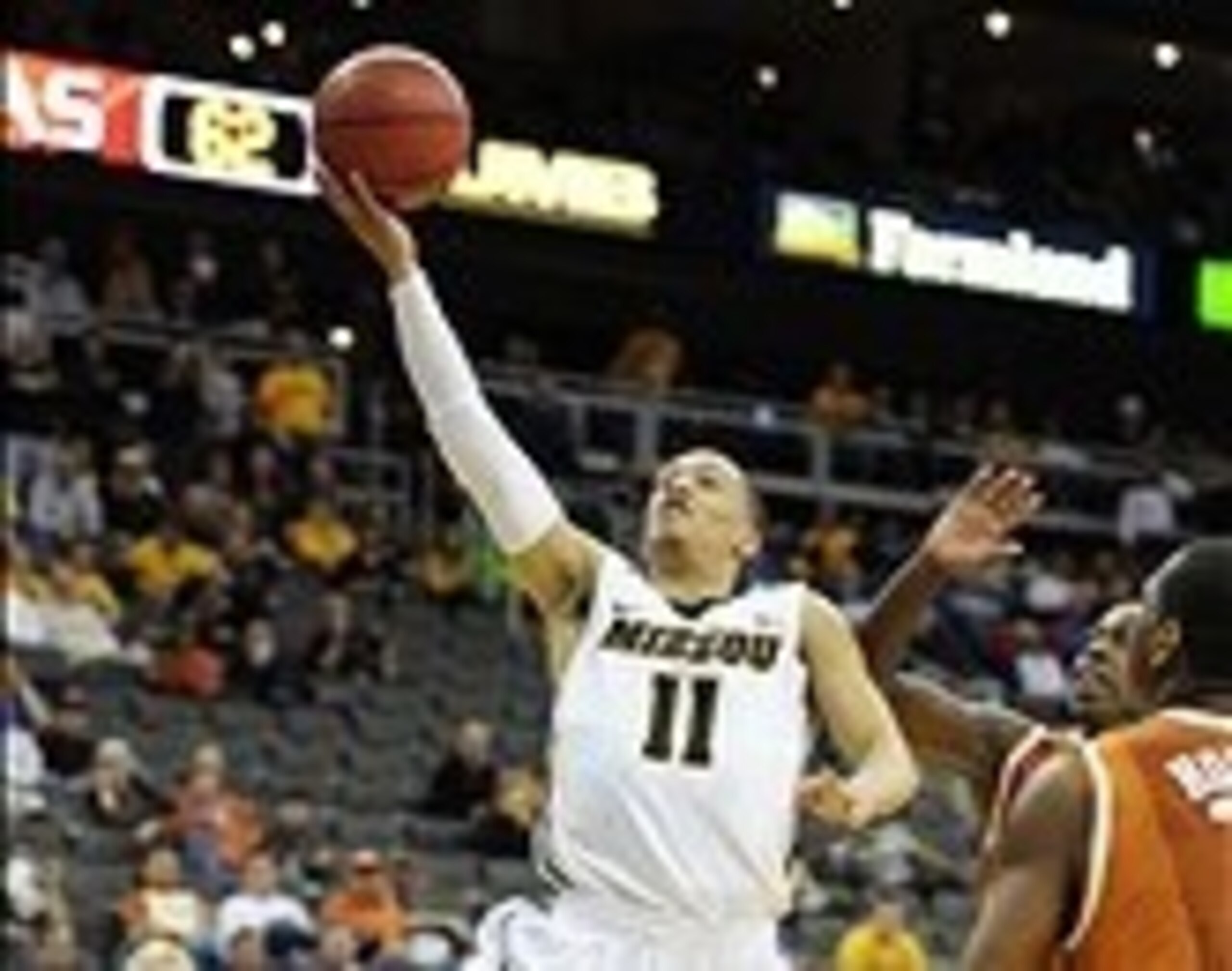 Mar 9, 2012; Kansas City, MO, USA; Missouri Tigers guard Michael Dixon Jr. (11) drives basket against the Texas Longhorns during the second half of the semifinal round of the Big 12 Tournament at the Sprint Center. Missouri defeated Texas 81-67. Mandator Mar 9, 2012; Kansas City, MO, USA; Missouri Tigers guard Michael Dixon Jr. (11) drives basket against the Texas Longhorns during the second half of the semifinal round of the Big 12 Tournament at the Sprint Center. Missouri defeated Texas 81-67. Mandator