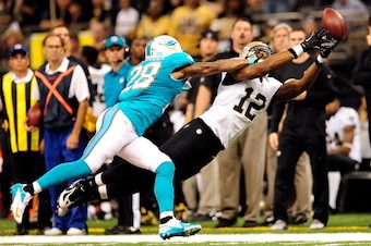 NEW ORLEANS, LA - SEPTEMBER 30:  Nolan Carroll #28 of the Miami Dolphins defends a pass intended for Marques Colston #12 of the New Orleans Saints during a game at the Mercedes-Benz Superdome on September 30, 2013 in New Orleans, Louisiana.  The Saints de