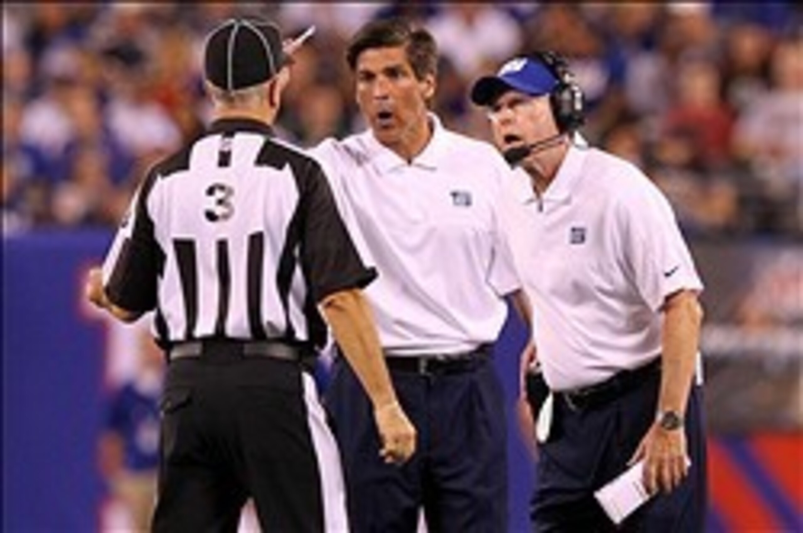 Special teams coordinator Tom Quinn (center) seems to have no answers for the coverage unit's struggles this year.