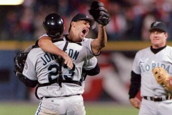 Brown celebrates his no-hitter with catcher Charles Johnson with Conine eager to join in the background.
