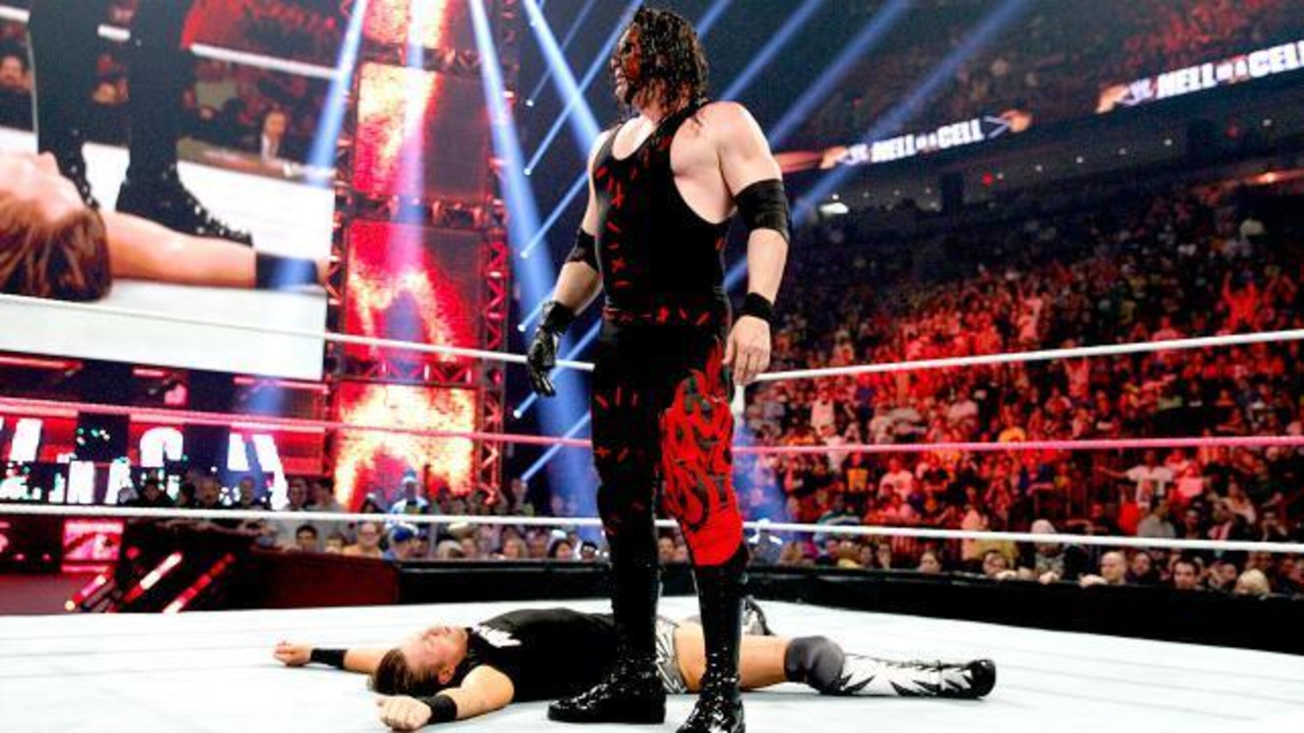 Kane lays out The Miz with a chokeslam.