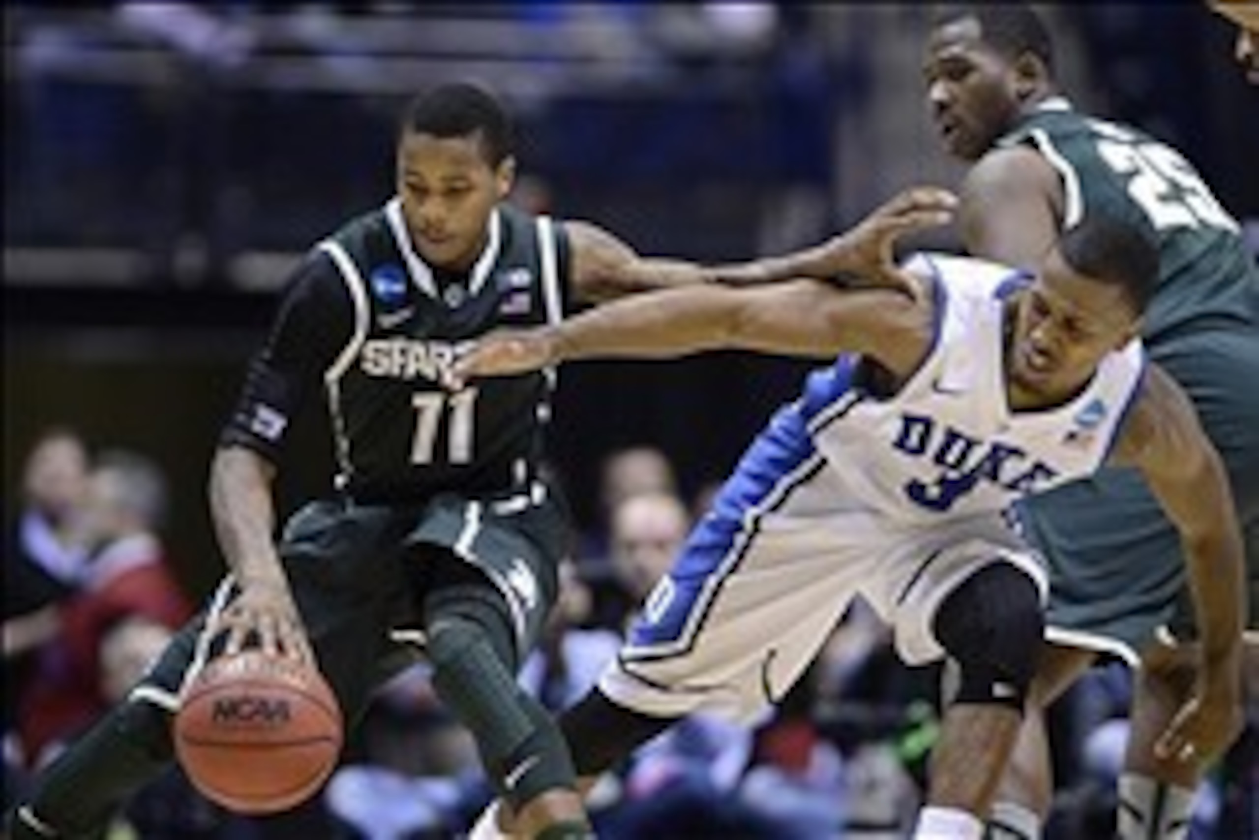 Mar 29, 2013; Indianapolis, IN, USA; Michigan State Spartans guard Keith Appling (11) and Duke Blue Devils guard Tyler Thornton (3) reach for the ball in the second half during the semifinals of the Midwest regional of the 2013 NCAA tournament at Lucas Oi