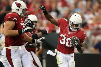 Andre Ellington (right) celebrates a touchdown.