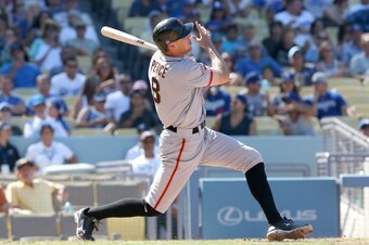 LOS ANGELES, CA - SEPTEMBER 15:  Hunter Pence #8 of the San Francisco Giants hits a two run home run in the sxth inning for his second home run of the game against the Los Angeles Dodgers at Dodger Stadium on September 15, 2013 in Los Angeles, California.