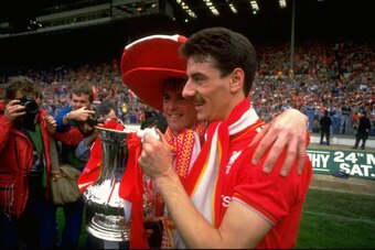 Kenny Dalglish (left) and Ian Rush (right) lift the FA Cup at Wembley