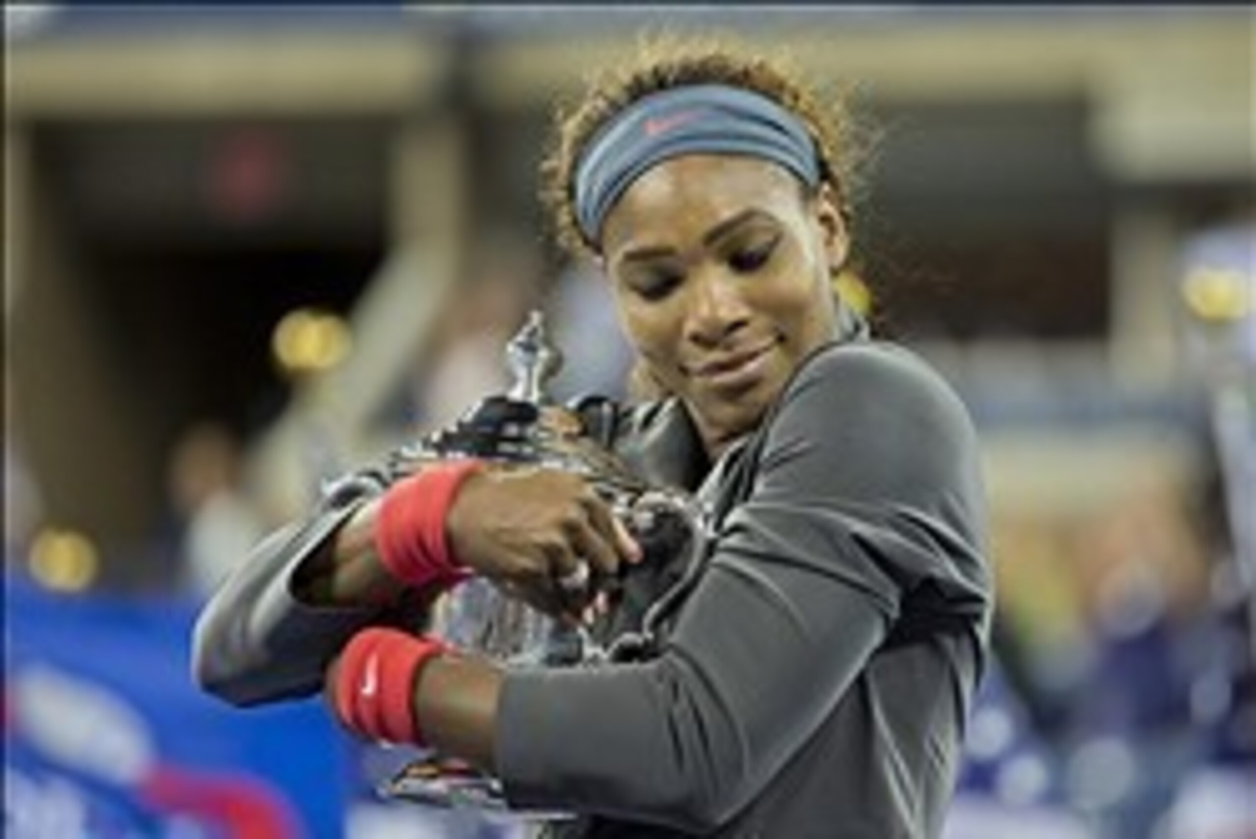 Serena Williams hugs trophy after winning 2013 U.S. Open.