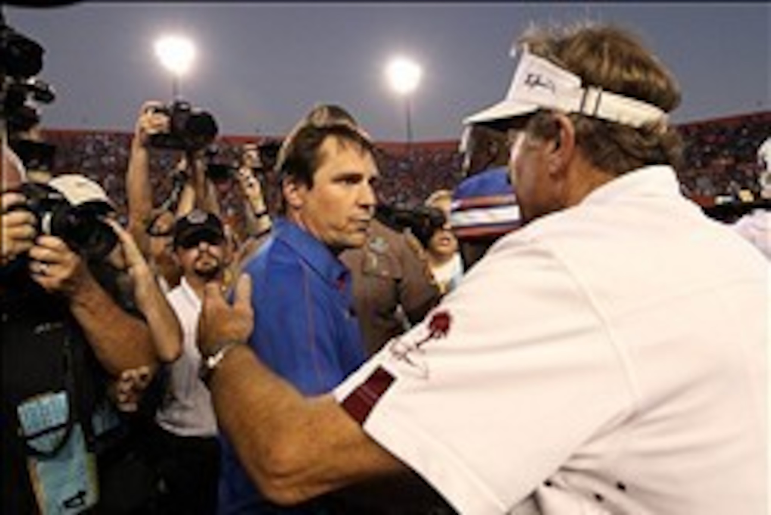 South Carolina coach Steve Spurrier (right) congratulates Florida coach Will Muschamp after the Gators' victory over the Gamecocks last season.