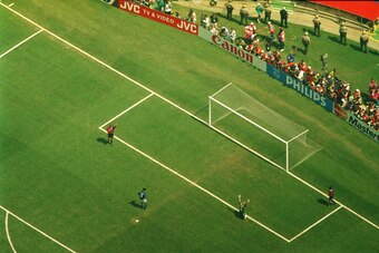 17 jun 1994: roberto baggio (in blue) misses the decisive penalty as brazilian goalkeeper claudio taffarel falls to his knees and raises his arms in victory as brazil wins the 1994 world cup final. Brazil won during a penaly shoot-out at the Rose Bowl sta