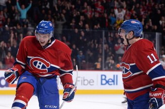 Alex Galchenyuk (left) celebrates a goal as Brendan Gallagher arrives.