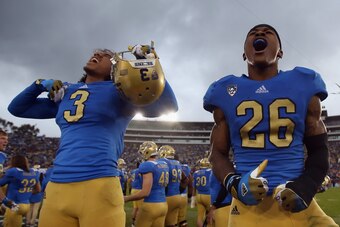 PASADENA, CA - NOVEMBER 17:  Randall Goforth #3 and Andrew Abbott #26 of the UCLA Bruins  celebrate their teams 38-28 victory over the USC Trojans at the Rose Bowl on November 17, 2012 in Pasadena, California.  (Photo by Jeff Gross/Getty Images)