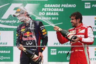 Alonso celebrates with Mark Webber on the podium