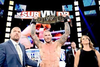 Randy Orton celebrates his successful WWE title defense with The Authority.