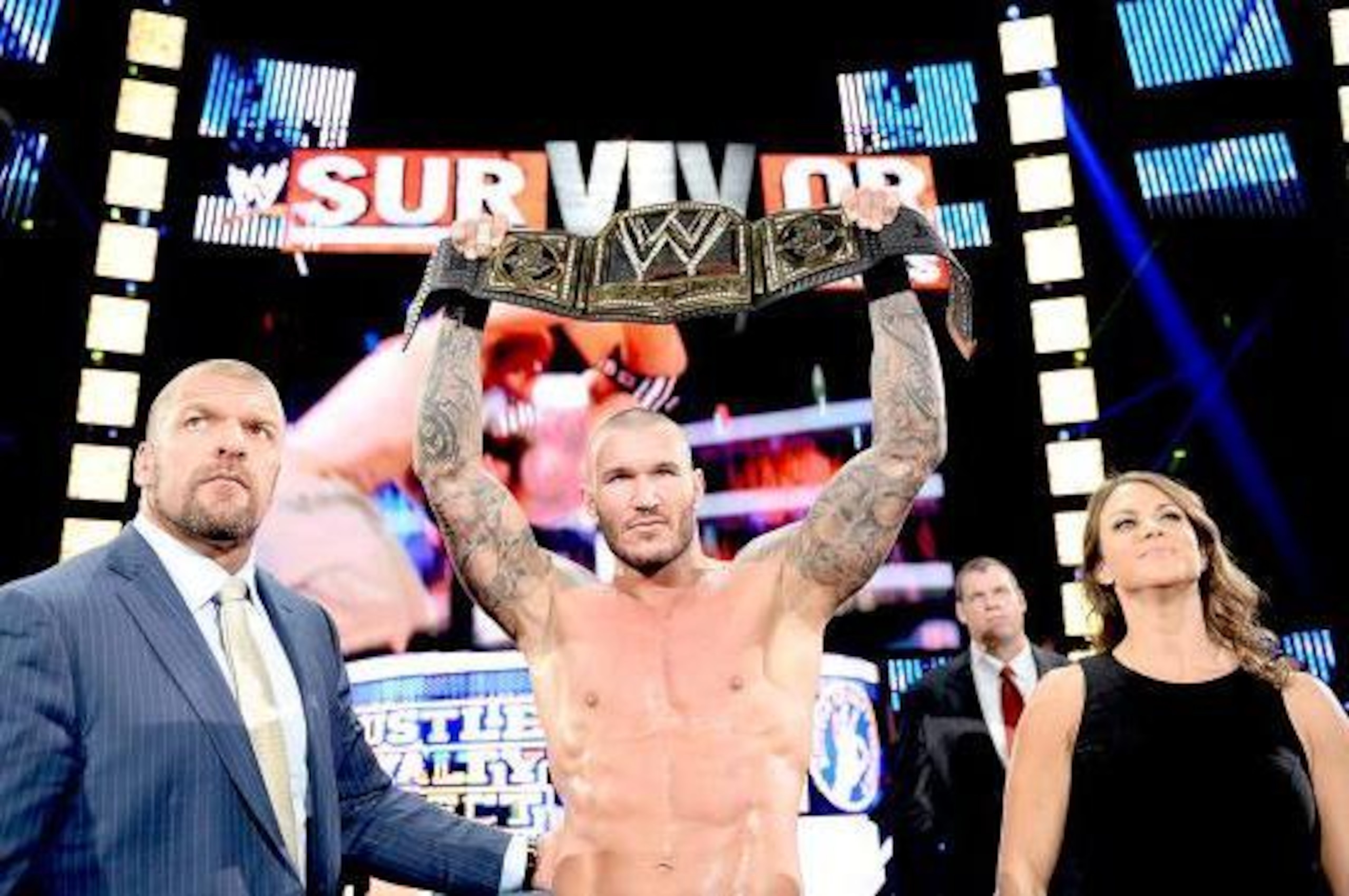 Randy Orton celebrates his successful WWE title defense with The Authority.