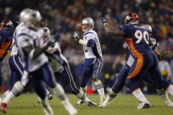 DENVER - NOVEMBER 3:  Quarterback Tom Brady #12 of the New England Patriots throws against the Denver Broncos late in the fourth quarter during Monday Night Football November 3, 2003 at Invesco Field at Mile High in Denver, Colorado  The Patriots won 30-2