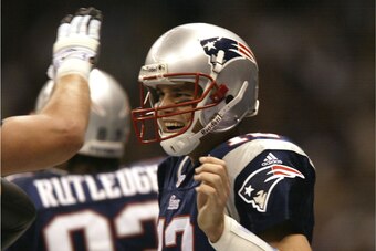 3 Feb 2002:  Quarterback Tom Brady #12 of the New England Patriots celebrates after throwing a touchdown pass to wide receiver to David Patten #86 to give the Patriots a 13-3 lead during the second quarter of Super Bowl XXXVI between the New England Patri