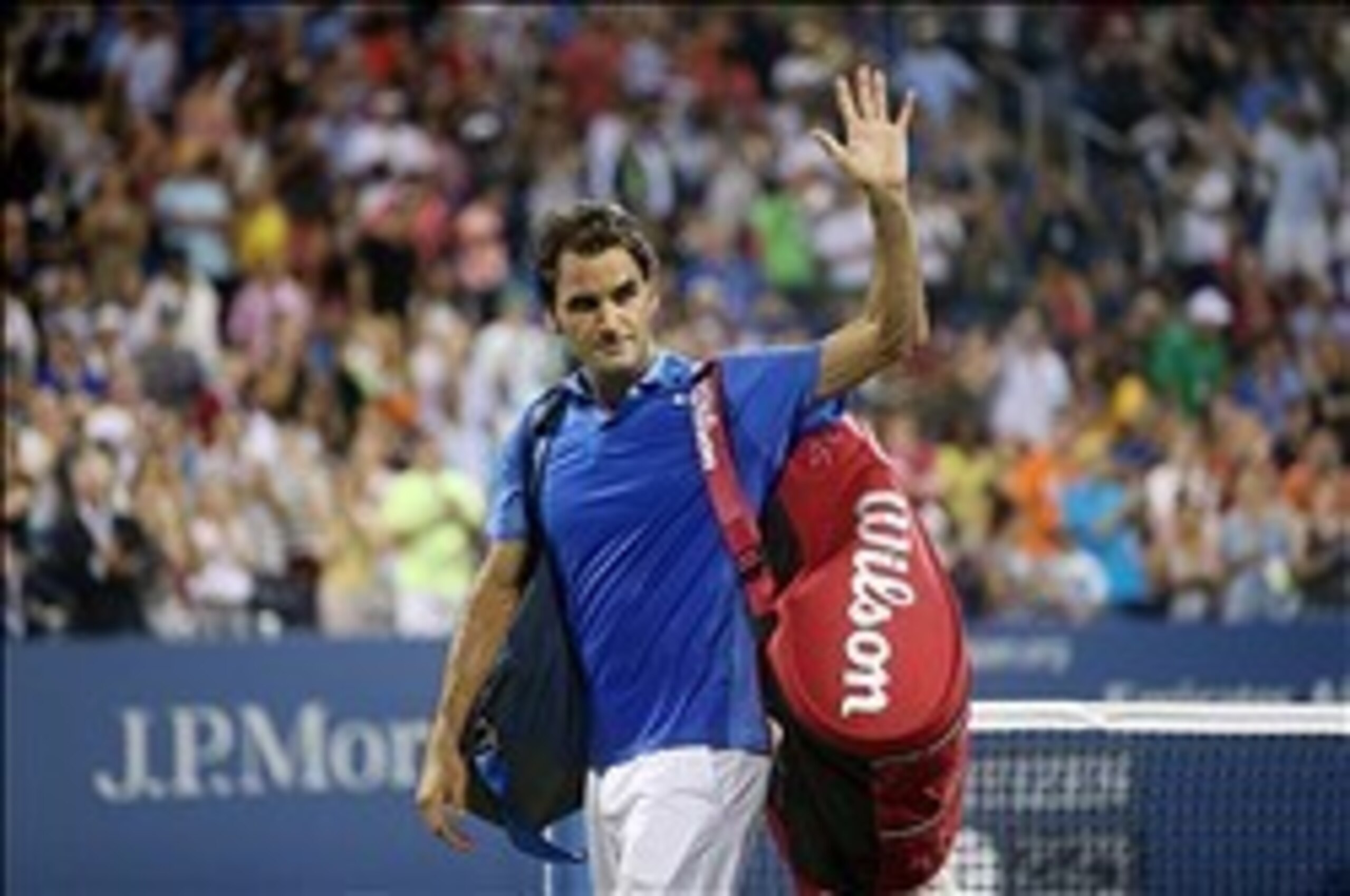 Roger Federer waves to the crowd as he leaves the court at the 2013 U.S. Open.