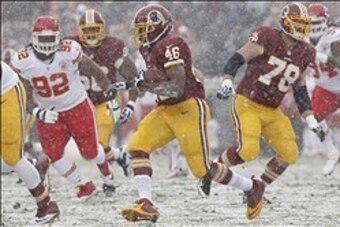 Dec 8, 2013; Landover, MD, USA; Washington Redskins running back Alfred Morris (46) carries the ball past Kansas City Chiefs nose tackle Dontari Poe (92) in the first quarter at FedEx Field. Mandatory Credit: Geoff Burke-USA TODAY Sports