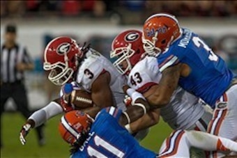 Nov 2, 2013; Jacksonville, FL, USA; Georgia Bulldogs running back Todd Gurley (3) is tackled by Florida Gators linebacker Neiron Ball (11) while Florida Gators linebacker Antonio Morrison (3) defends Georgia Bulldogs linebacker Tommy Long (43) during the 