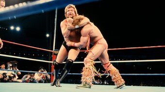 Ted DiBiase grabs hold of Ultimate Warrior.